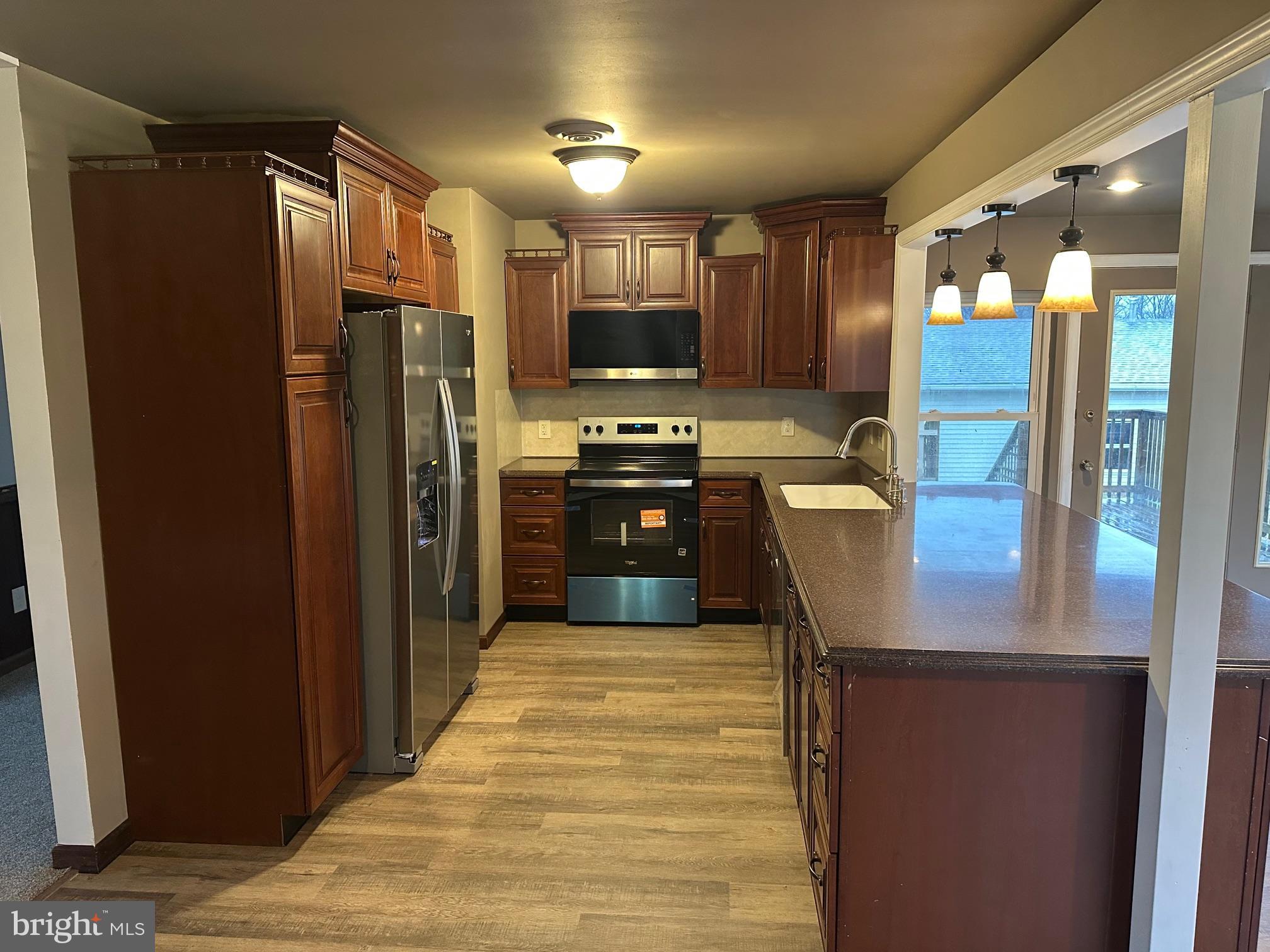 2562 Long Lebanon, PA 17046 - Photo 3 of 16 a kitchen with stainless steel appliances granite countertop a refrigerator and a sink