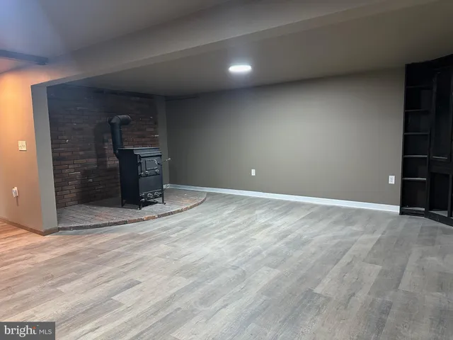 a view of empty room with a fireplace