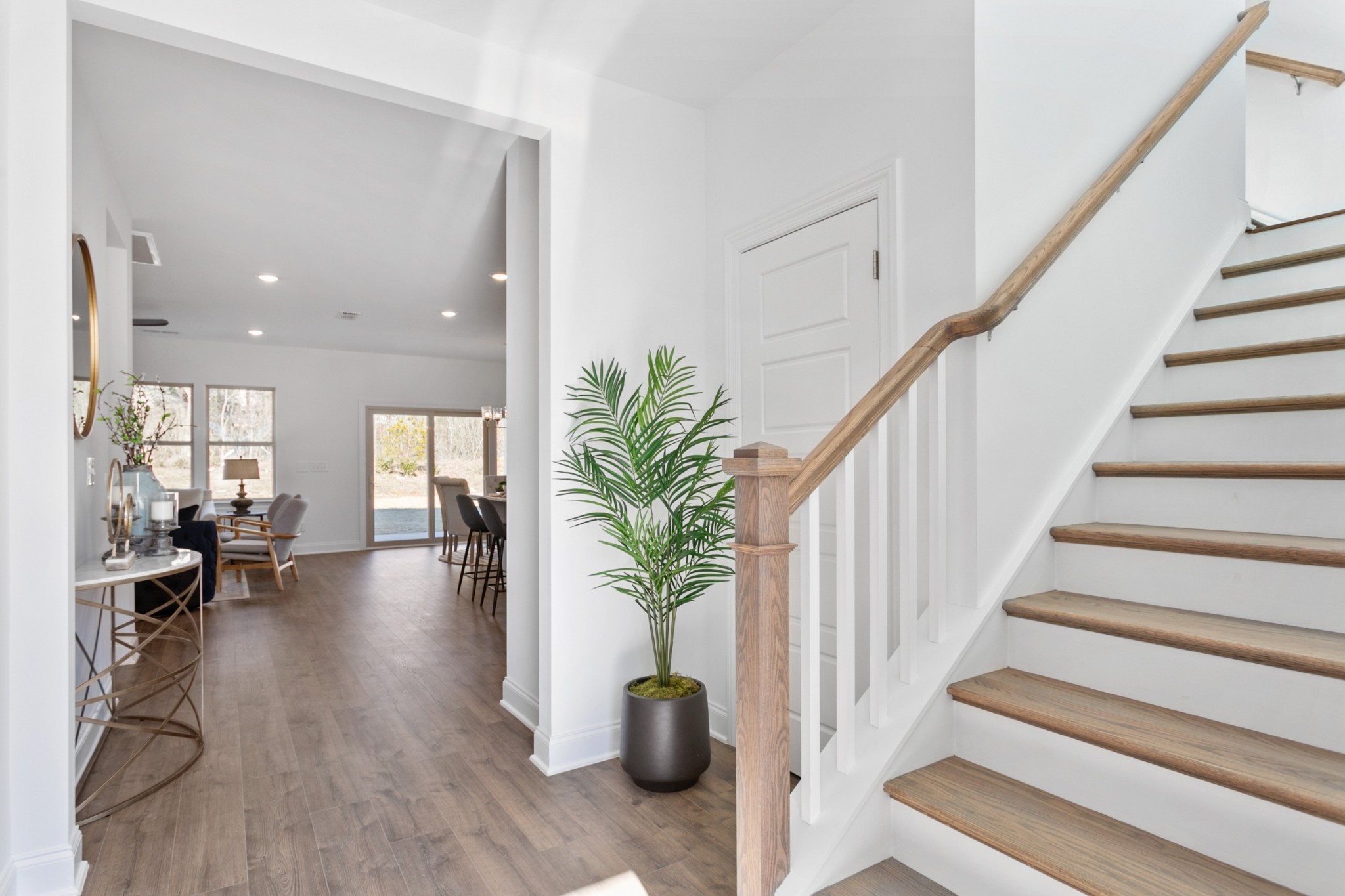 1104 Riverview Run Madison, TN 37115 - Photo 3 of 55 a hallway with wooden floor and a potted plant