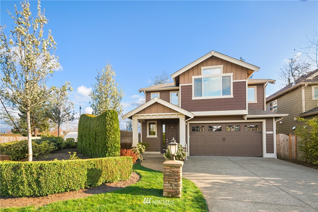 5639 Northeast 7th Place Renton, WA 98059 - Photo 2 of 23 a front view of a house with a yard and garage