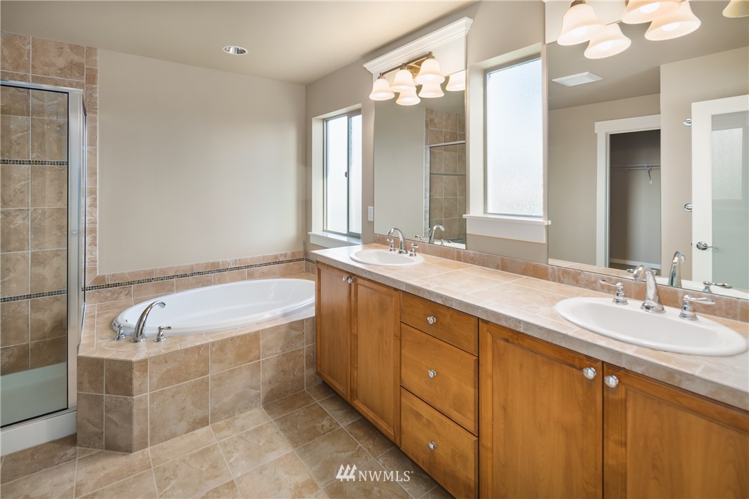 5639 Northeast 7th Place Renton, WA 98059 - Photo 23 of 23 a spacious bathroom with a tub sink and mirror