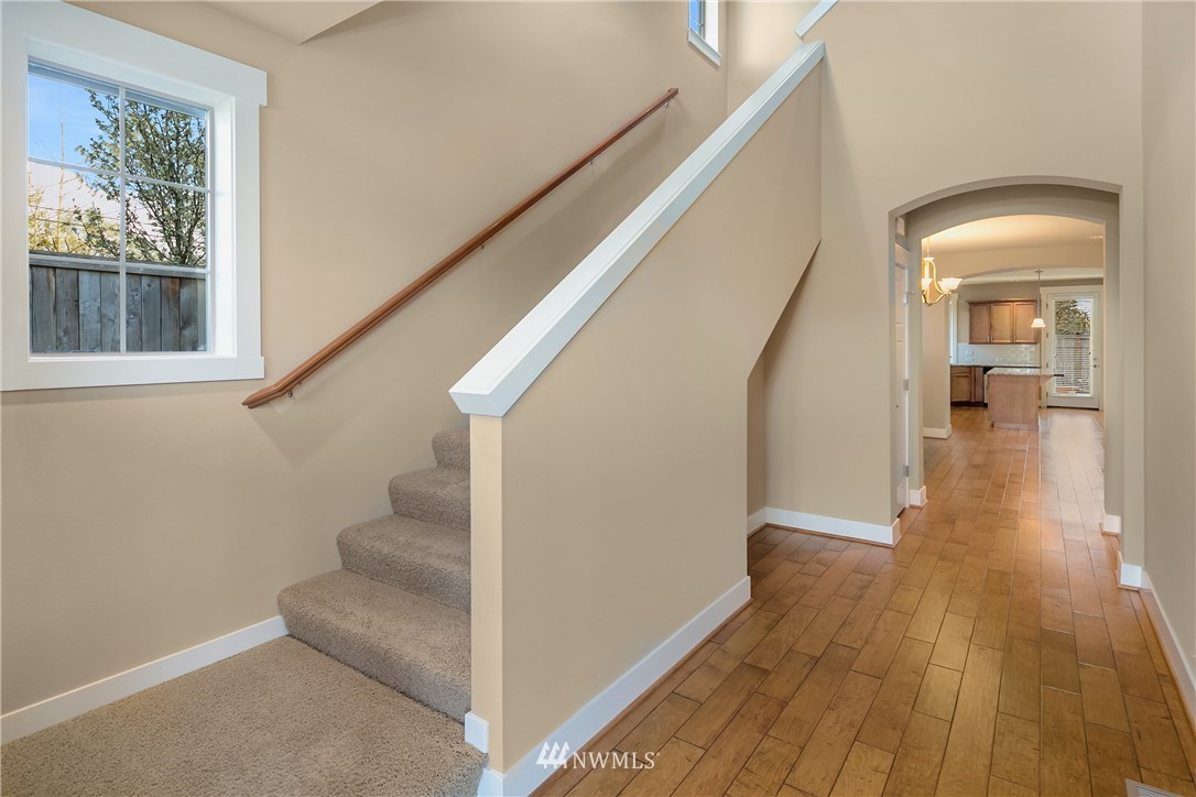 5639 Northeast 7th Place Renton, WA 98059 - Photo 4 of 23 a view of a hallway view with wooden floor and staircase