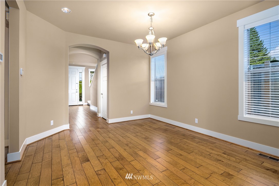 5639 Northeast 7th Place Renton, WA 98059 - Photo 6 of 23 a view of an empty room with wooden floor and a window