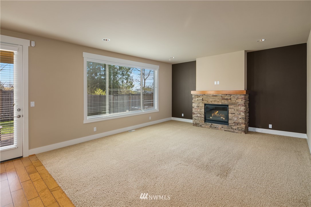 5639 Northeast 7th Place Renton, WA 98059 - Photo 10 of 23 an empty room with fireplace and a window