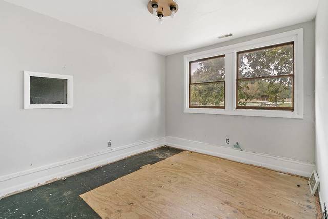 W4019 Black Point Road Lake Geneva, WI 53147 - Photo 11 of 23 a view of an empty room with a window and wooden floor