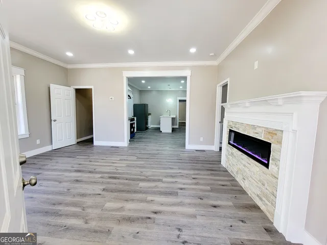 a view of a hallway with a livingroom with a fireplace