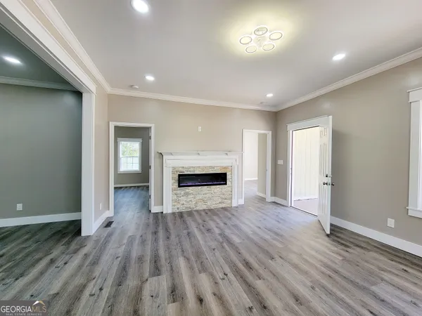 a view of empty room with wooden floor