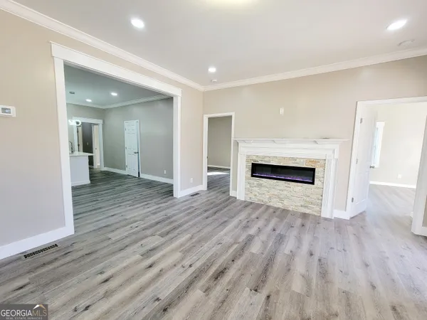 a view of a hallway with wooden floor and a fireplace