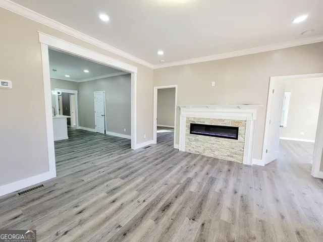 a view of a hallway with wooden floor and a fireplace