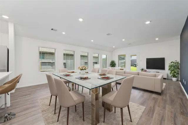 a view of a dining room with furniture window and wooden floor