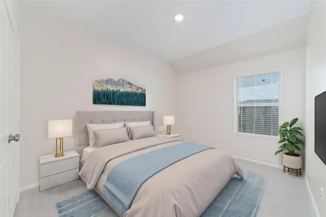 a bedroom with a bed and a potted plant