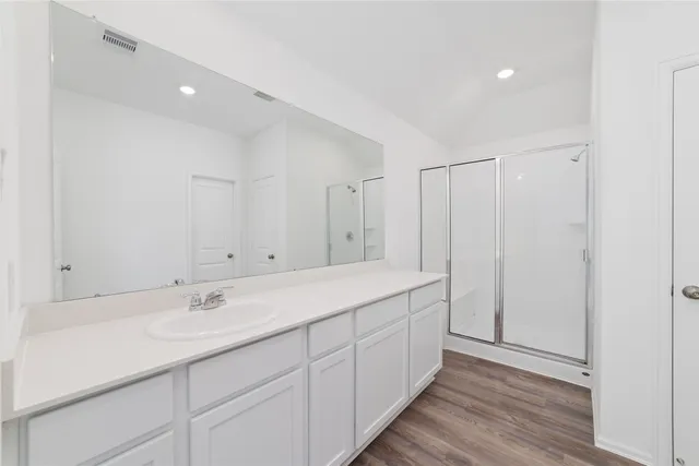 a bathroom with a double vanity sink and mirror