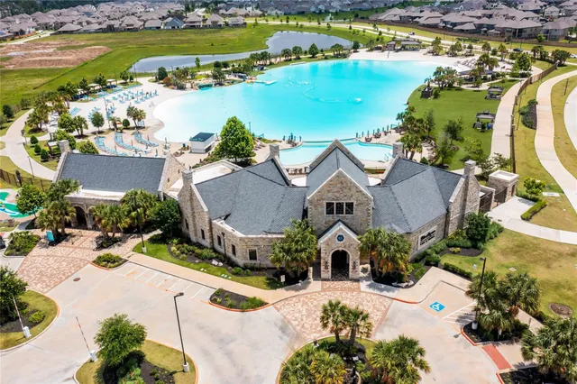 an aerial view of a house with a swimming pool yard and outdoor seating