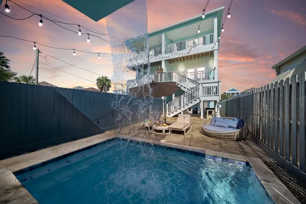 a backyard of a house with table and chairs