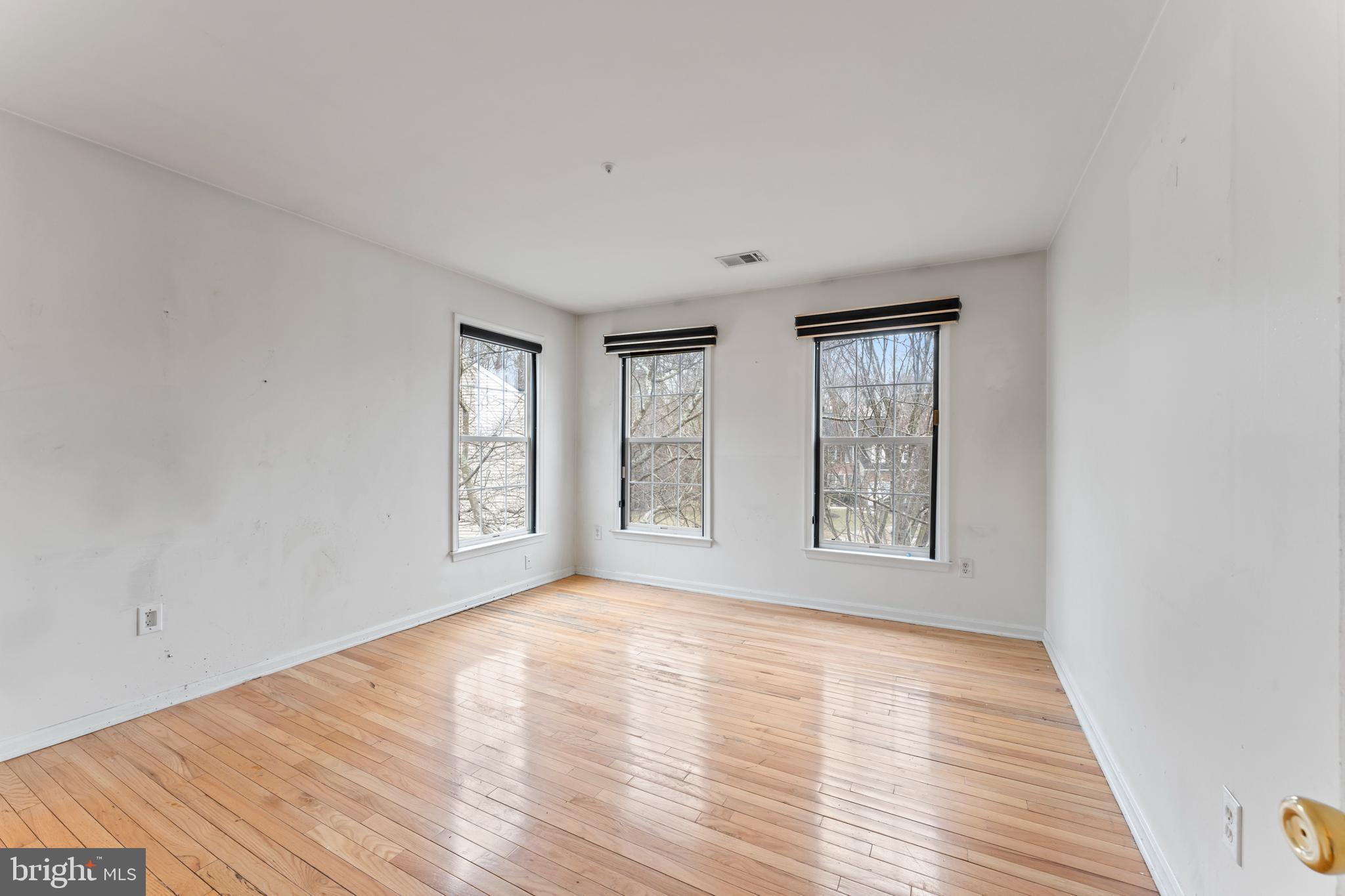 10110 Goose Pond Court Laurel, MD 20708 - Photo 18 of 46 a view of an empty room with wooden floor and a window