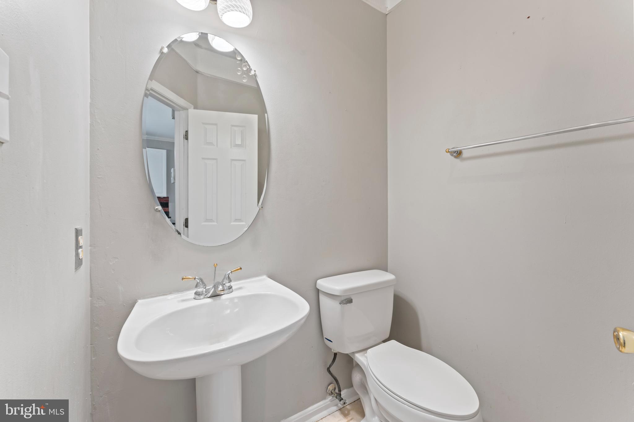 10110 Goose Pond Court Laurel, MD 20708 - Photo 23 of 46 a bathroom with a toilet sink and mirror