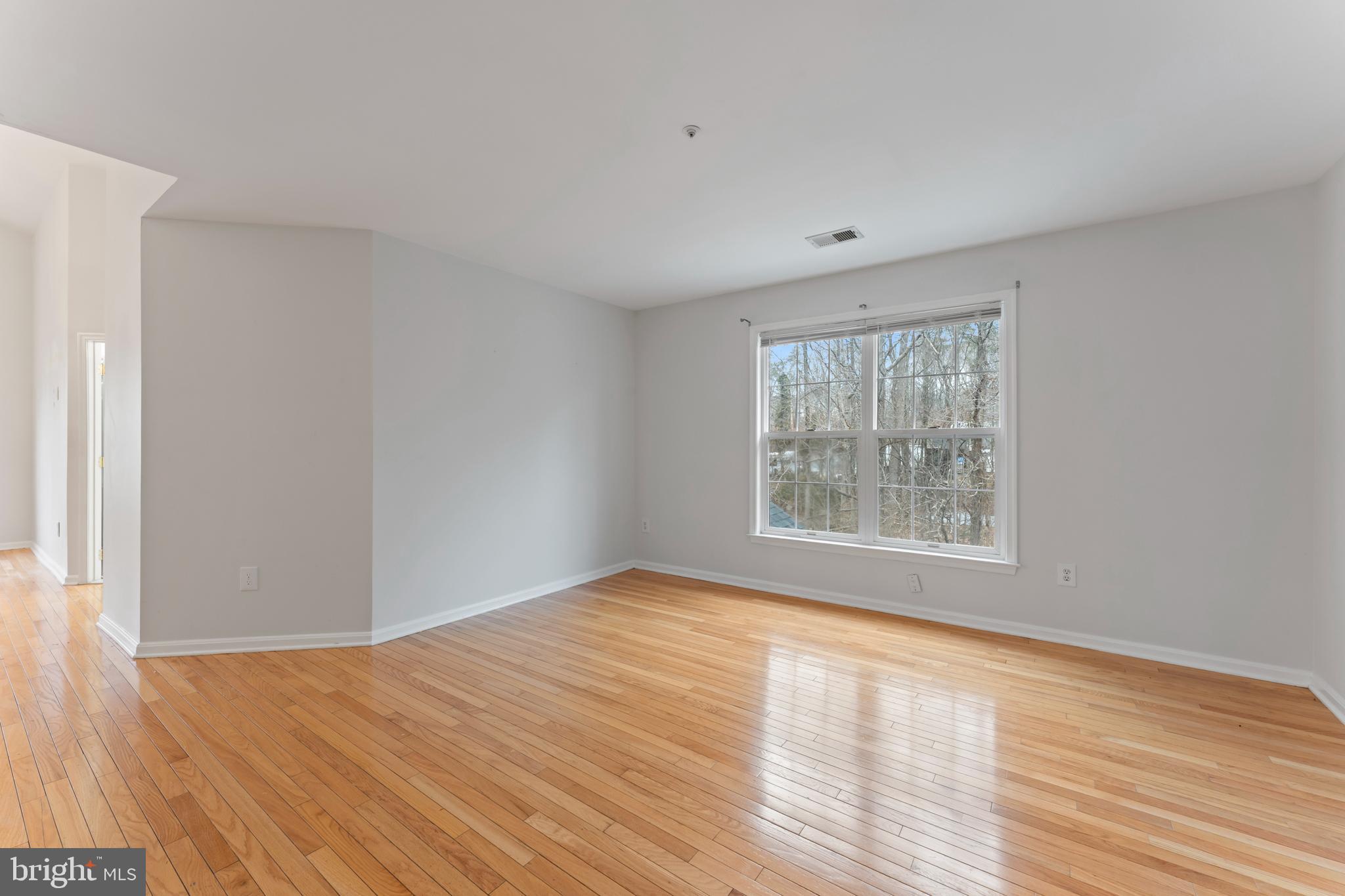 10110 Goose Pond Court Laurel, MD 20708 - Photo 28 of 46 a view of an empty room with wooden floor and a window