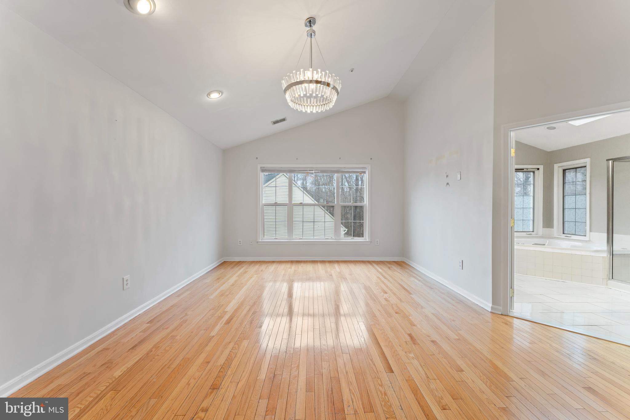 10110 Goose Pond Court Laurel, MD 20708 - Photo 31 of 46 a view of an empty room with wooden floor and a window