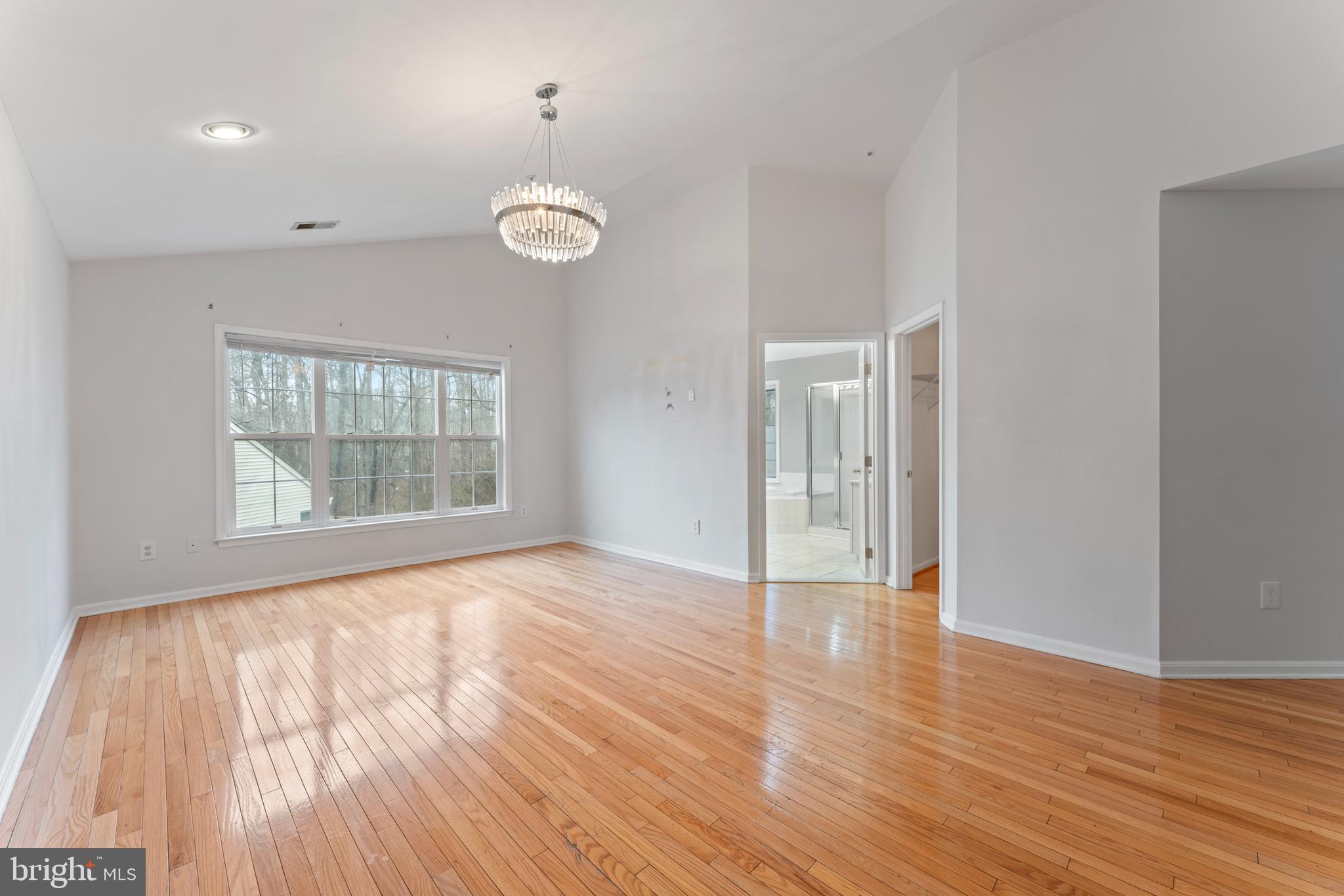10110 Goose Pond Court Laurel, MD 20708 - Photo 32 of 46 an empty room with wooden floor and windows