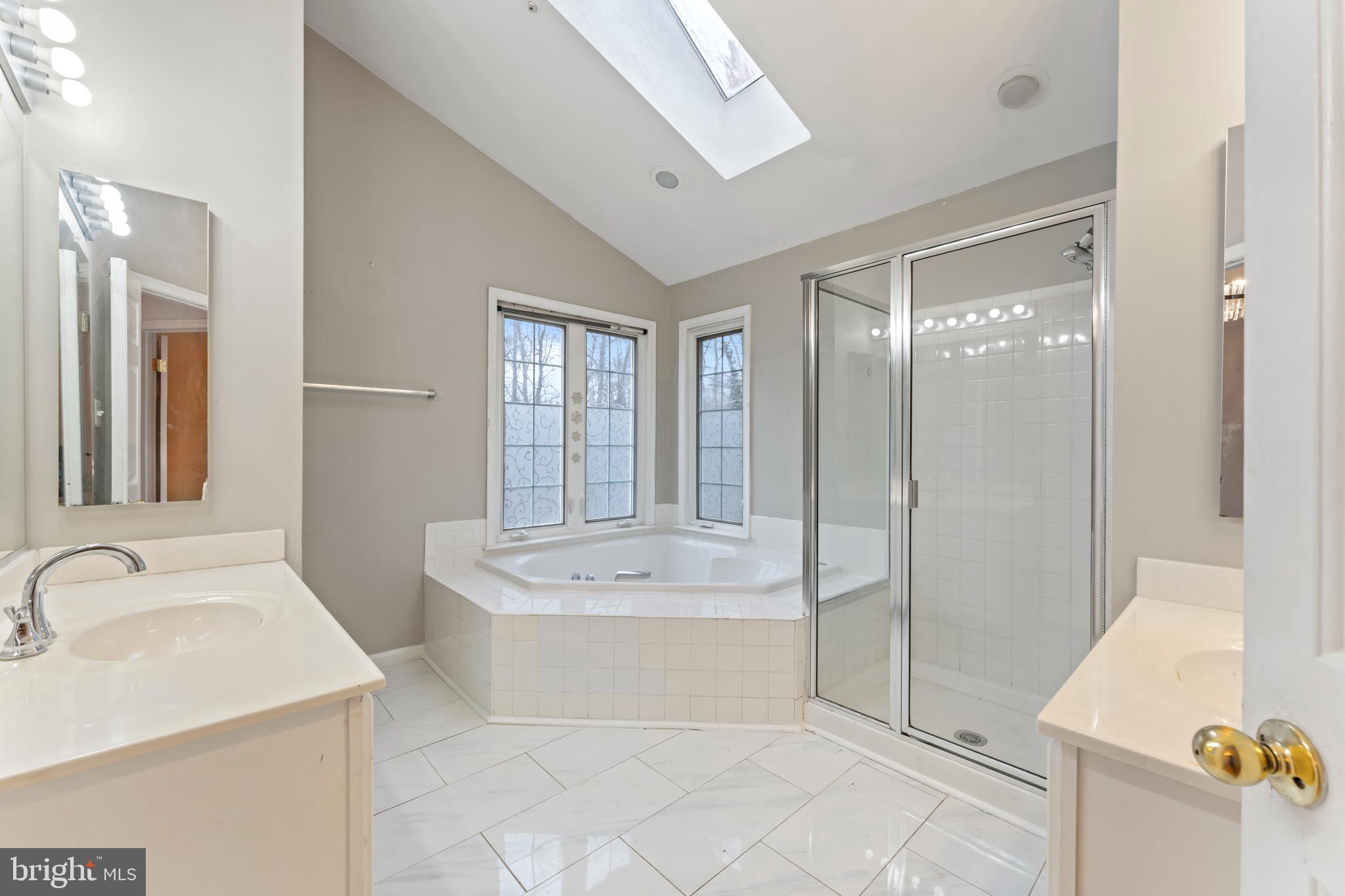 10110 Goose Pond Court Laurel, MD 20708 - Photo 35 of 46 a bathroom with a tub sink and mirror