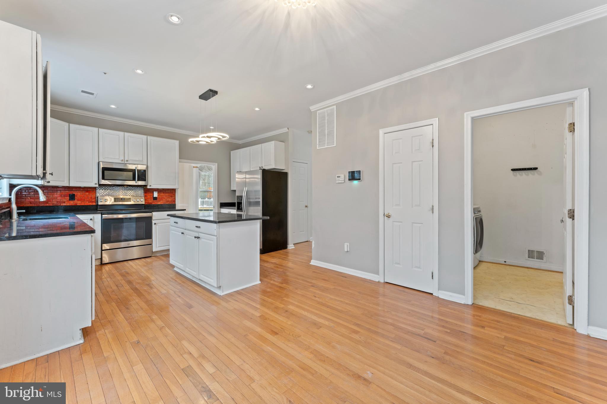 10110 Goose Pond Court Laurel, MD 20708 - Photo 7 of 46 a kitchen with stainless steel appliances a refrigerator and a stove top oven