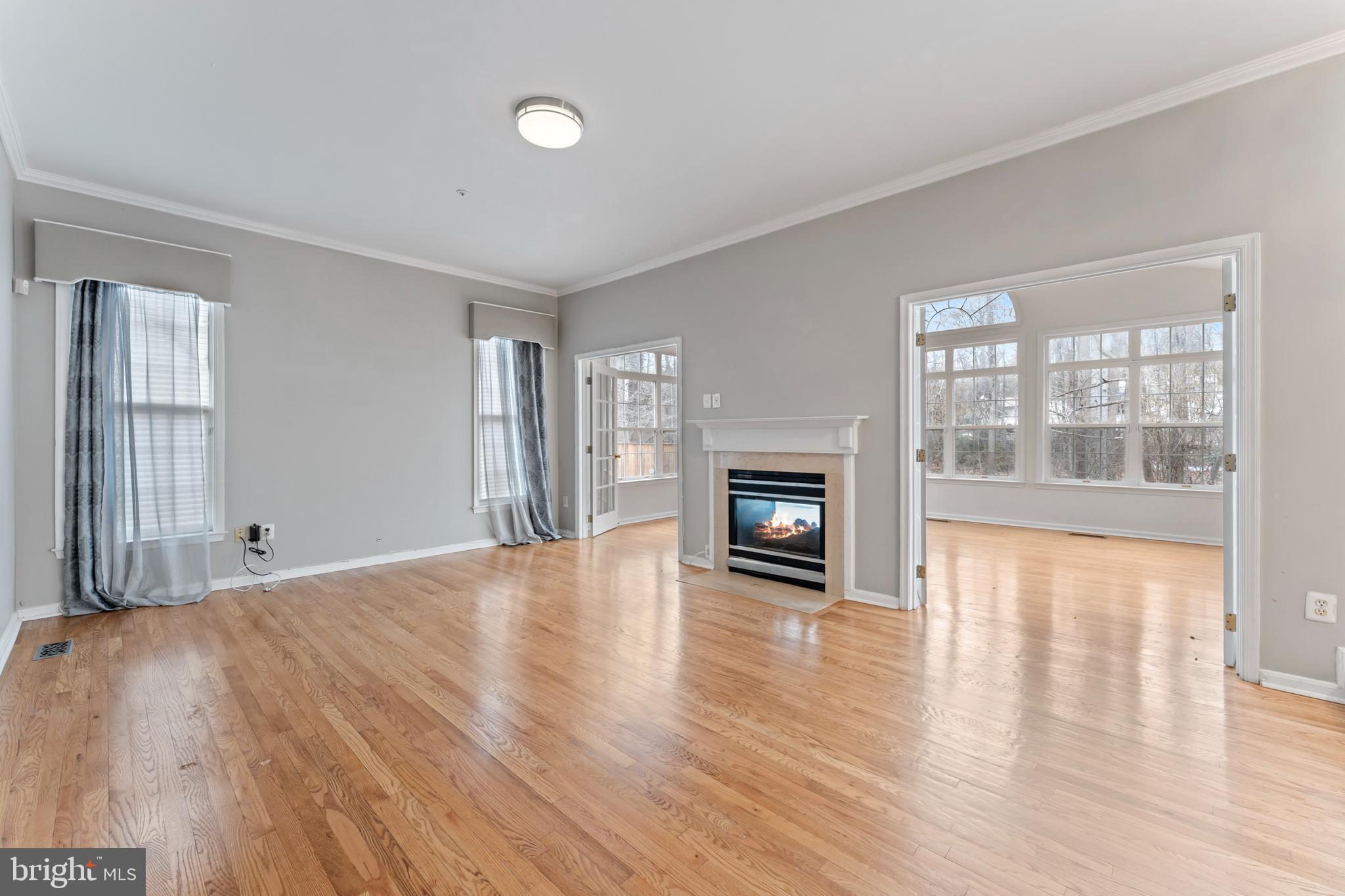 10110 Goose Pond Court Laurel, MD 20708 - Photo 9 of 46 a view of empty room with wooden floor and fireplace