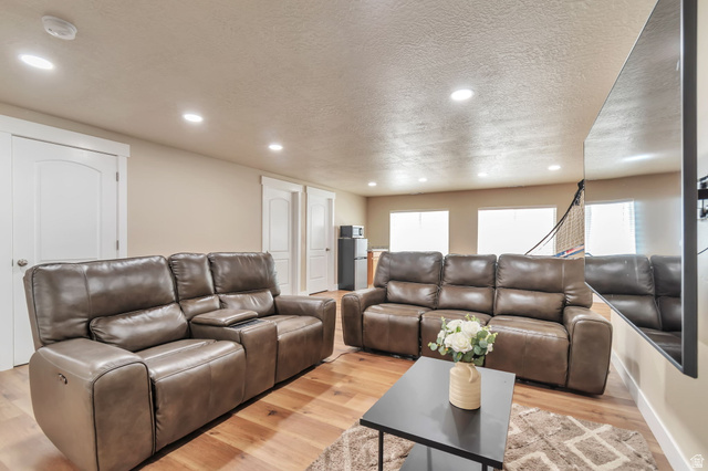 13038 Tower Ridge Drive Riverton, UT 84096 - Photo 22 of 30 Spacious entertainment area featuring recessed lighting, light wood-finish flooring, and multiple windows