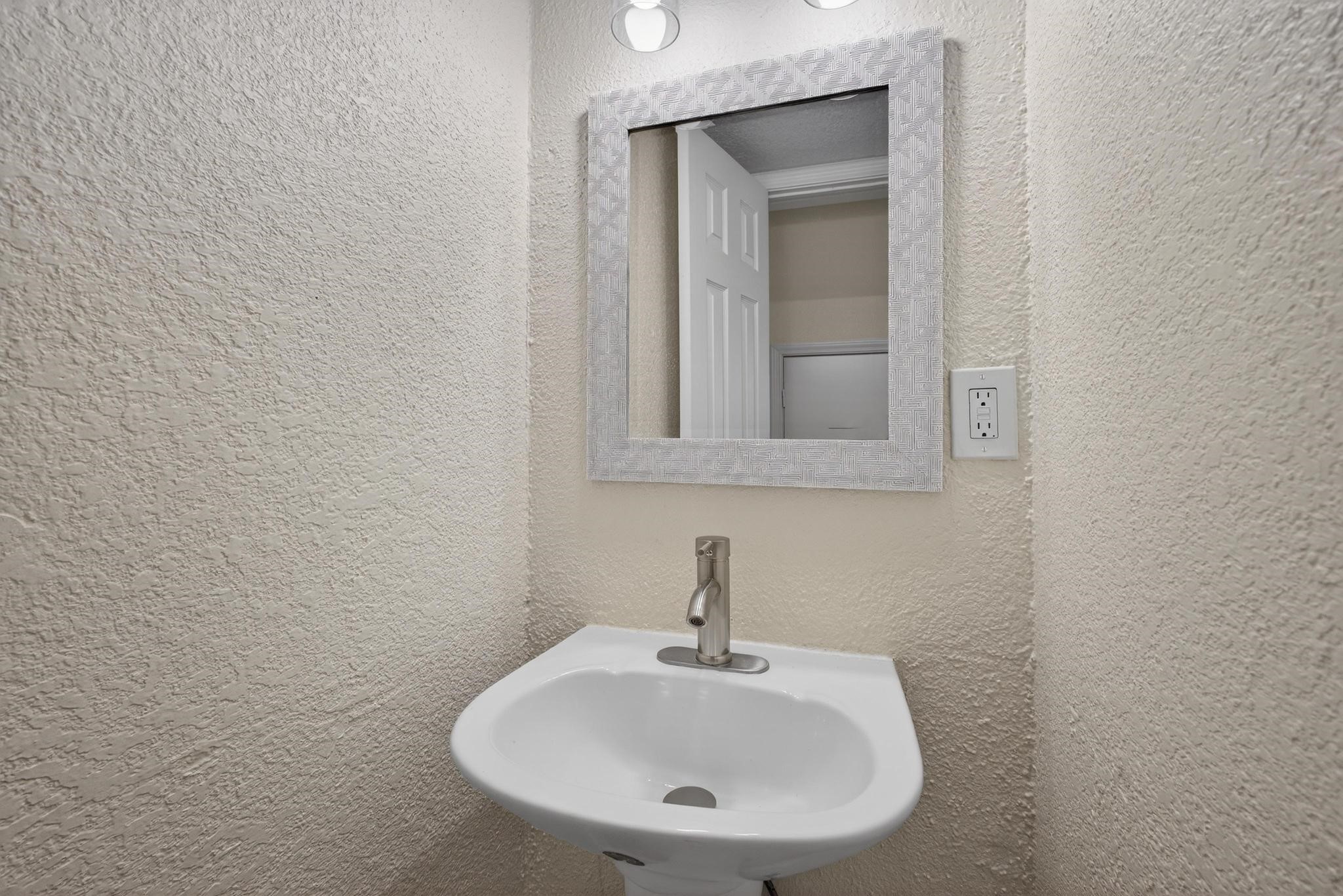 1221 Cedar Post Lane, Unit 1D Houston, TX 77055 - Photo 13 of 24 a bathroom with a sink and a mirror