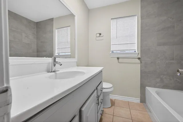 a bathroom with a sink a toilet and bathtub