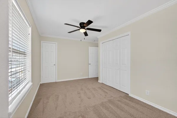 a view of a livingroom with a ceiling fan and window