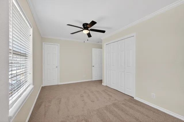 a view of a livingroom with a ceiling fan and window