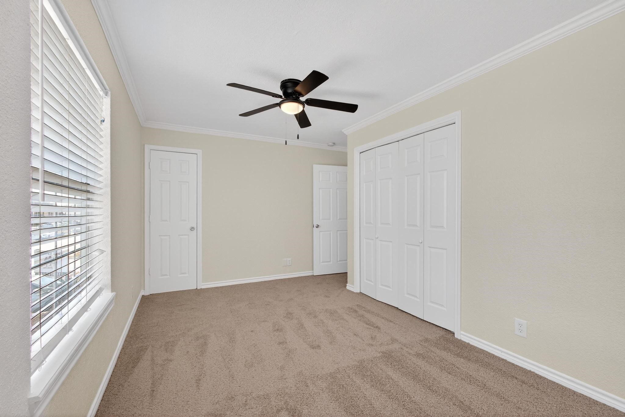 1221 Cedar Post Lane, Unit 1D Houston, TX 77055 - Photo 20 of 24 a view of a livingroom with a ceiling fan and window