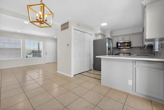 a kitchen with stainless steel appliances granite countertop a refrigerator and a stove top oven