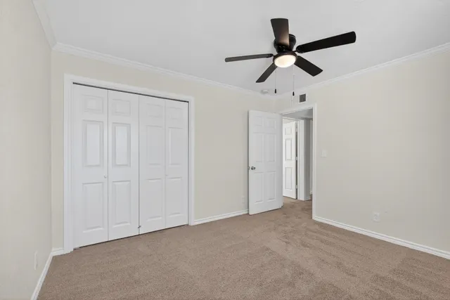 a view of empty room with ceiling fan