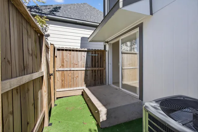 a kitchen with wooden floor and a window