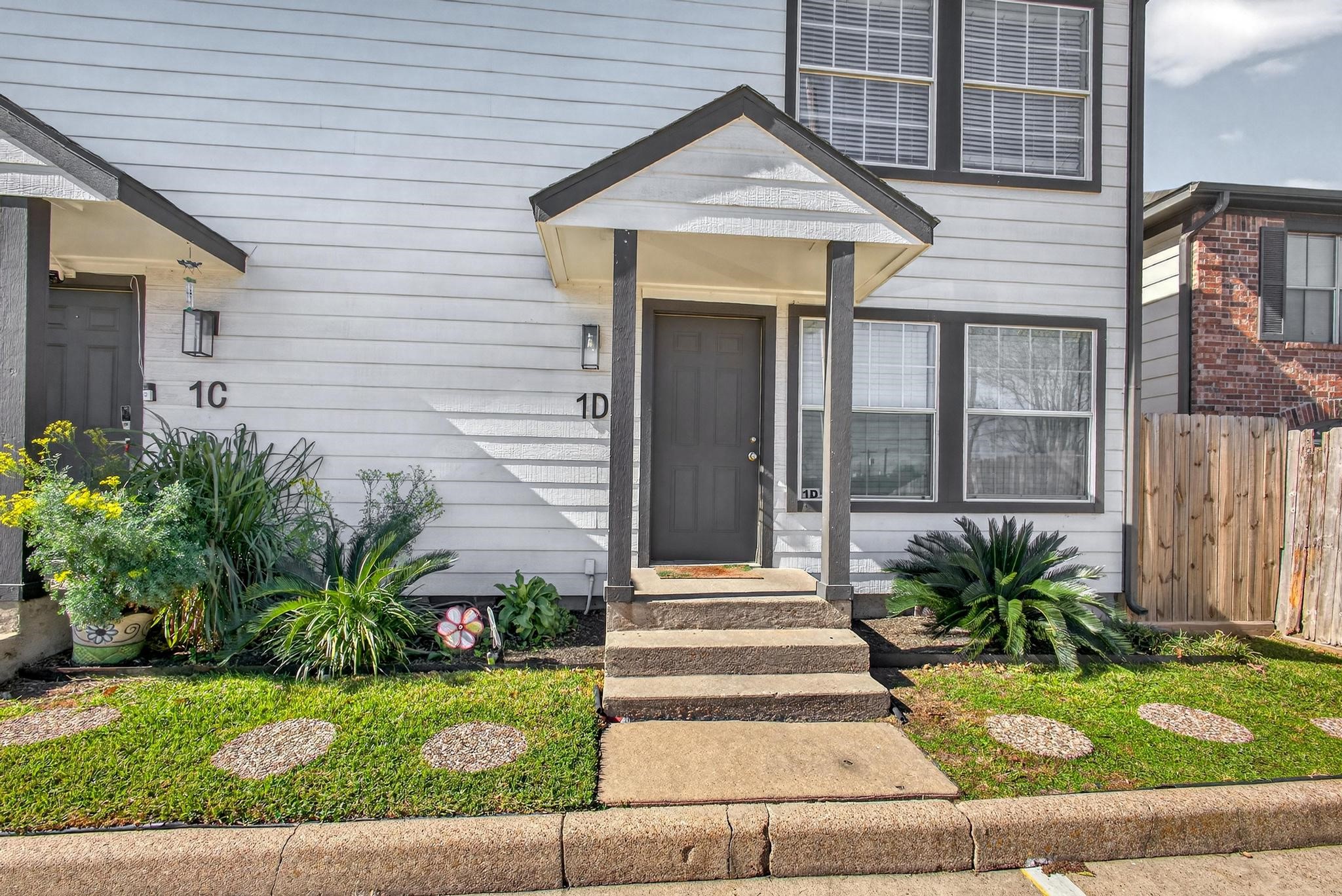 1221 Cedar Post Lane, Unit 1D Houston, TX 77055 - Photo 24 of 24 a front view of a house with garden