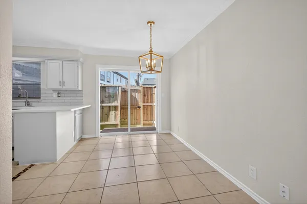 a view of a kitchen with wooden floor and a window