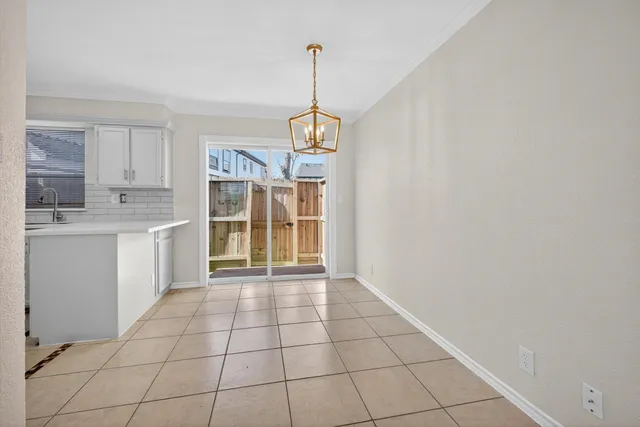 a view of a kitchen with wooden floor and a window