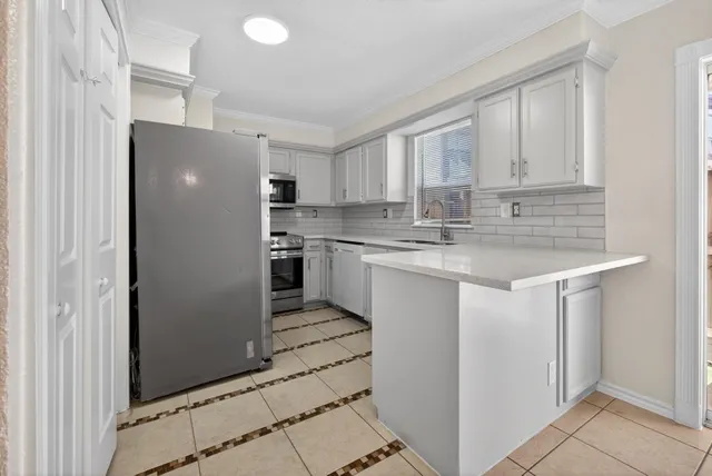 a kitchen with stainless steel appliances granite countertop a refrigerator sink and cabinets