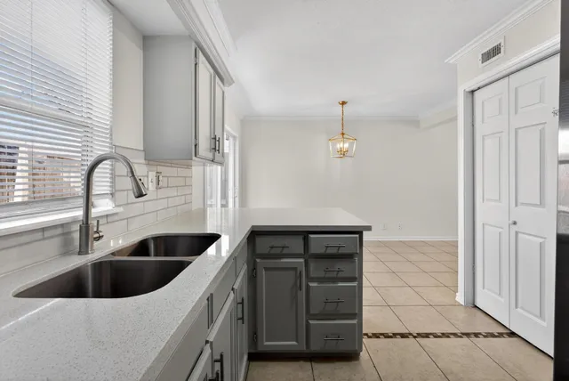 a kitchen with a sink and cabinets
