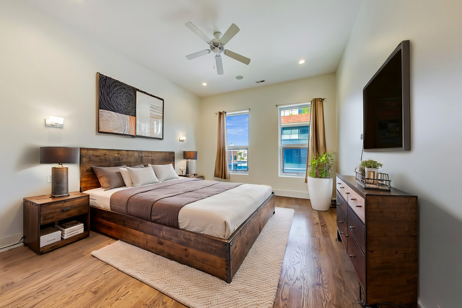 821 West Fulton Market, Unit 2 Chicago, IL 60607 - Photo 11 of 20 a bedroom with a large bed a flat tv screen and a dresser