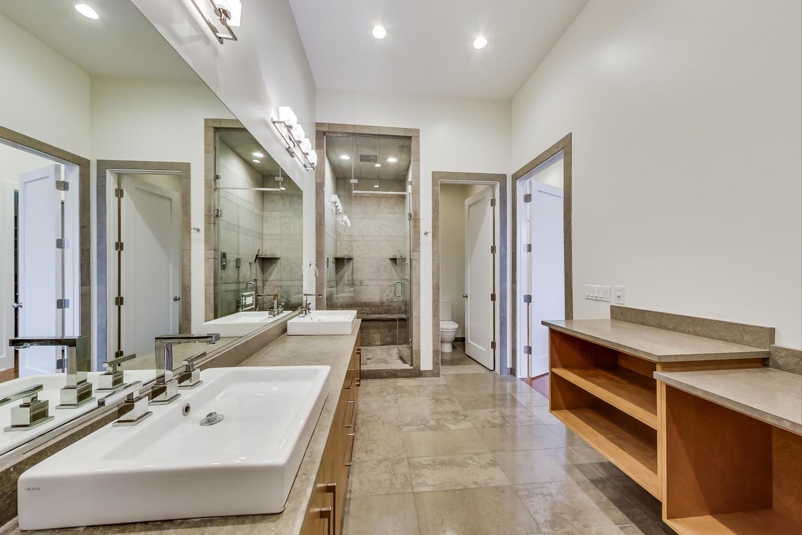 821 West Fulton Market, Unit 2 Chicago, IL 60607 - Photo 13 of 20 a bathroom with a tub double vanity sink and mirrors