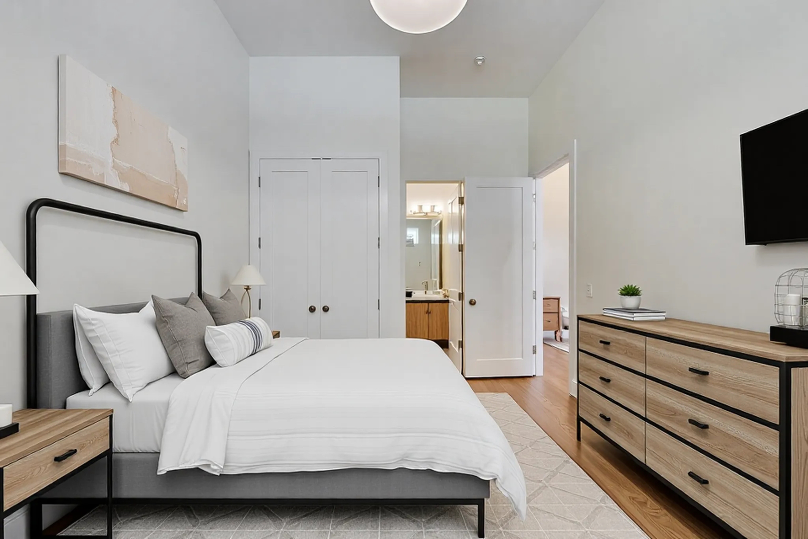 821 West Fulton Market, Unit 2 Chicago, IL 60607 - Photo 15 of 20 a spacious bedroom with a bed and a flat screen tv