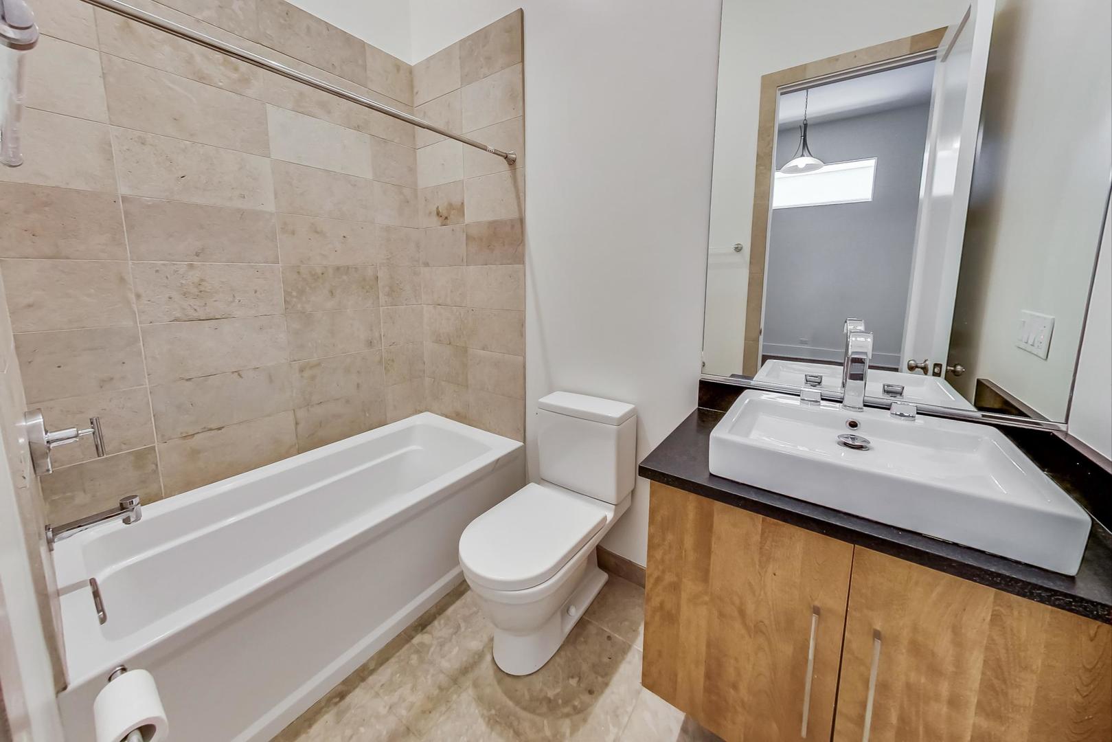 821 West Fulton Market, Unit 2 Chicago, IL 60607 - Photo 16 of 20 a bathroom with a sink toilet and shower