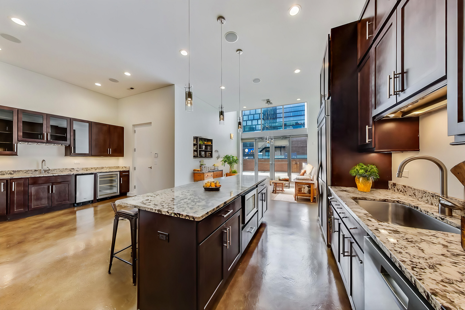 821 West Fulton Market, Unit 2 Chicago, IL 60607 - Photo 5 of 20 a large kitchen with stainless steel appliances granite countertop a large stove a sink dishwasher a oven and a dining table with wooden floor
