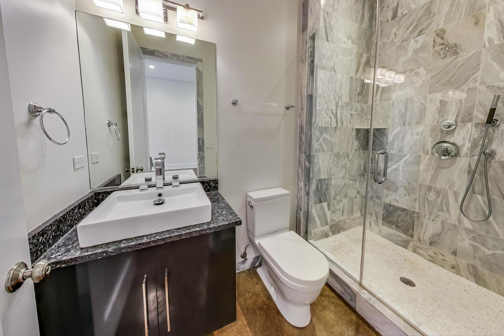 821 West Fulton Market, Unit 2 Chicago, IL 60607 - Photo 10 of 20 a bathroom with a sink toilet and shower