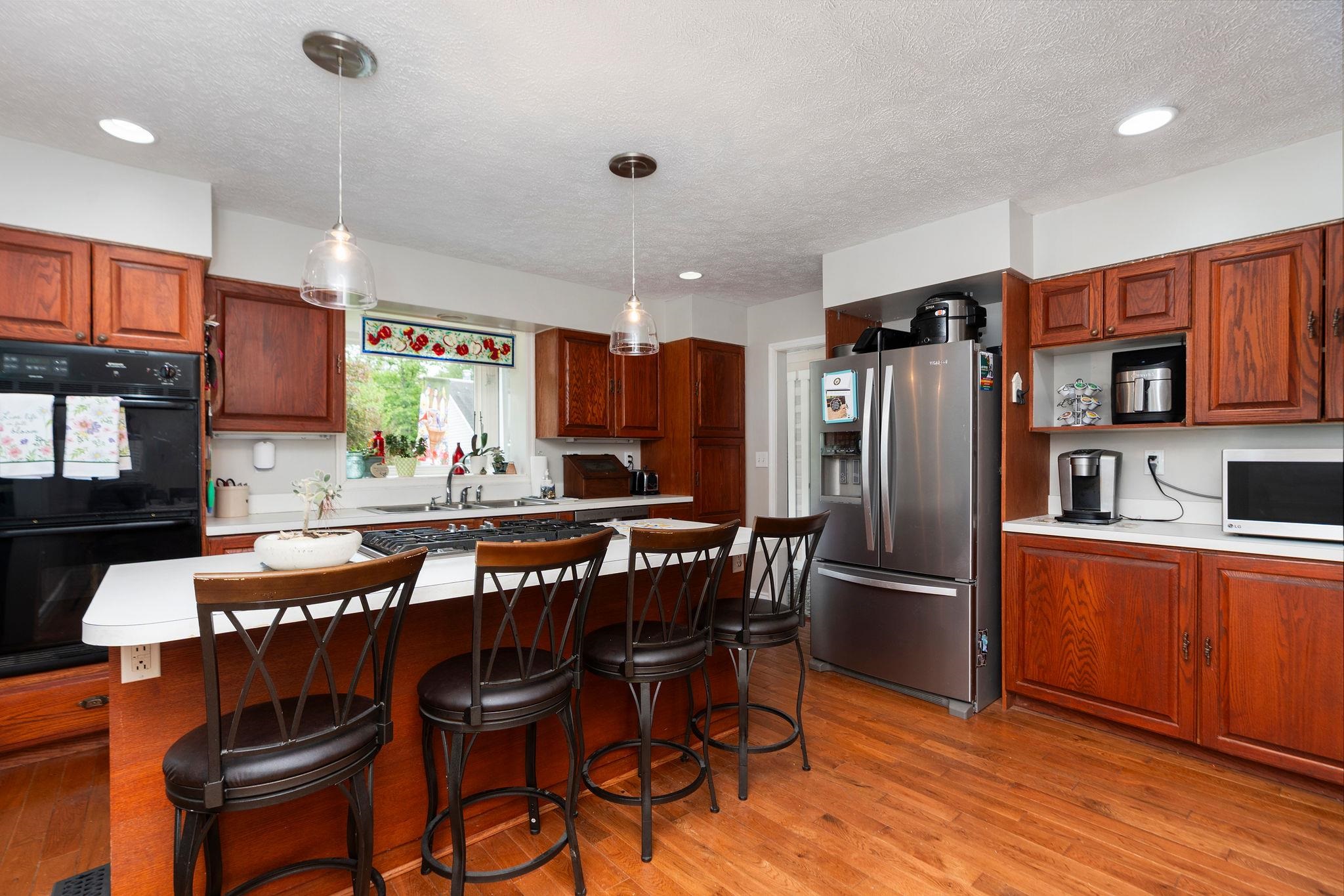 516 Estaline Valley Road Craigsville, VA 24430 - Photo 10 of 75 a kitchen with stainless steel appliances granite countertop a dining table chairs refrigerator and microwave