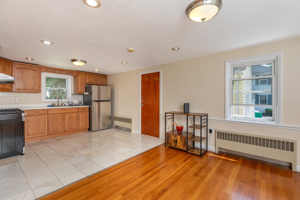 21 Allerton Road Milton, MA 02186 - Photo 13 of 42 a view of a kitchen with a sink cabinets and a living room