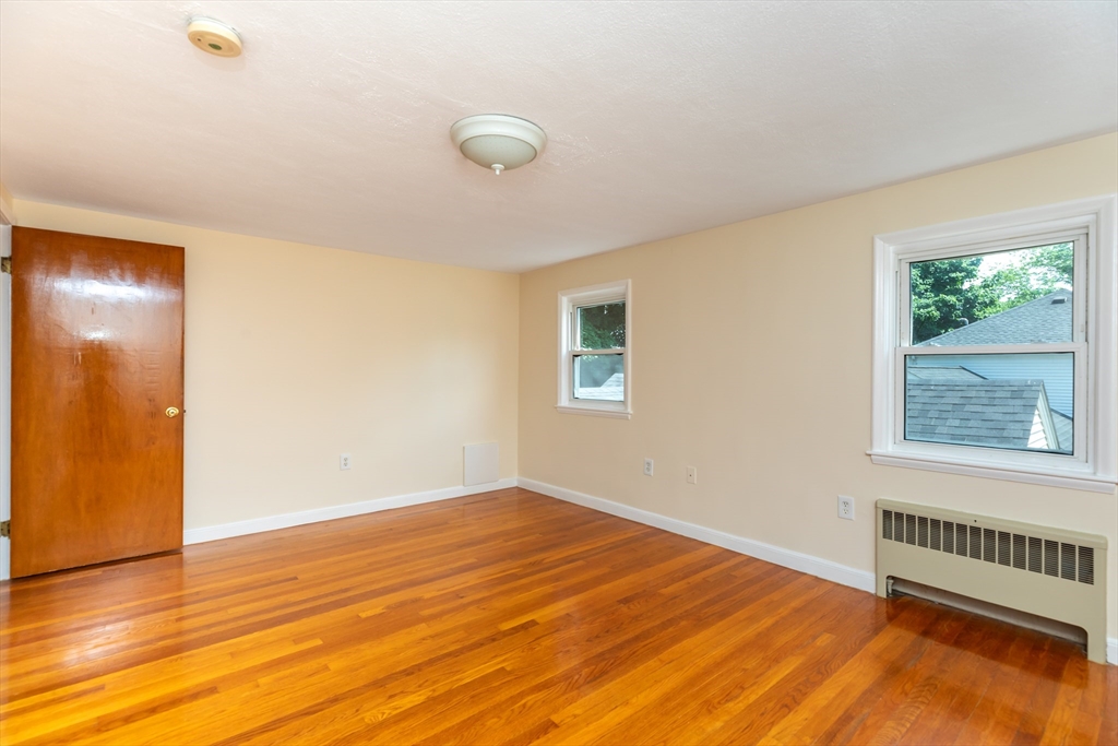 21 Allerton Road Milton, MA 02186 - Photo 16 of 42 a view of an empty room with wooden floor and a window