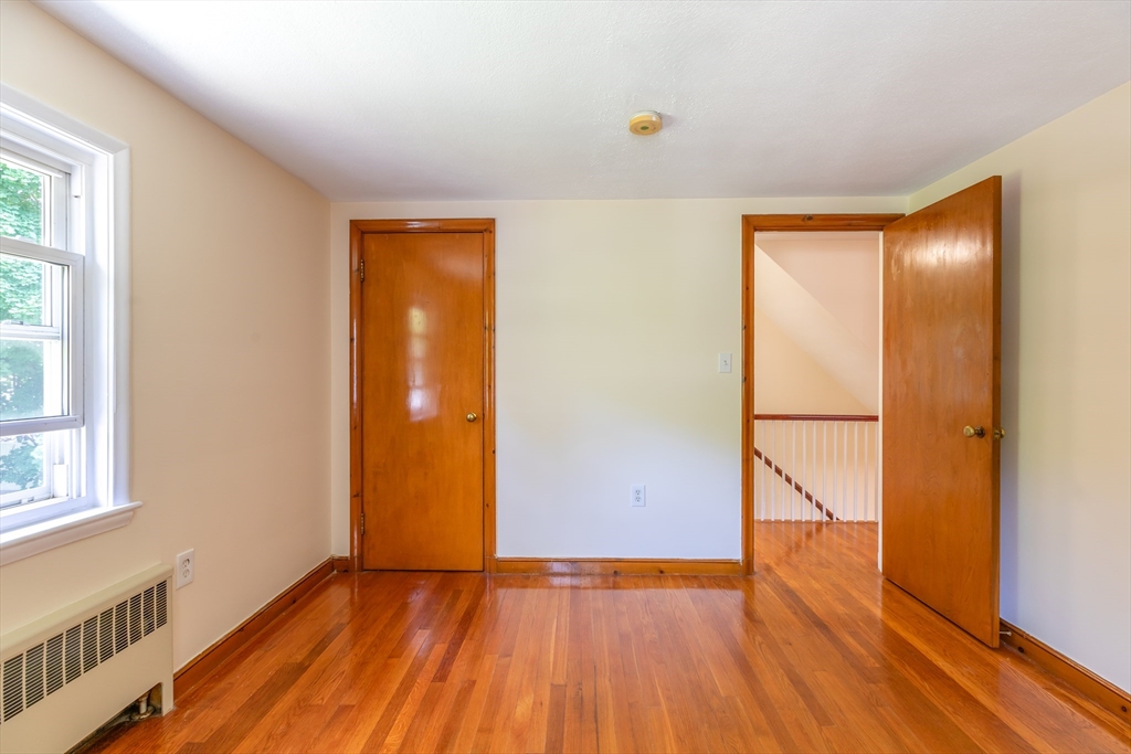 21 Allerton Road Milton, MA 02186 - Photo 17 of 42 a view of an empty room with wooden floor and a window